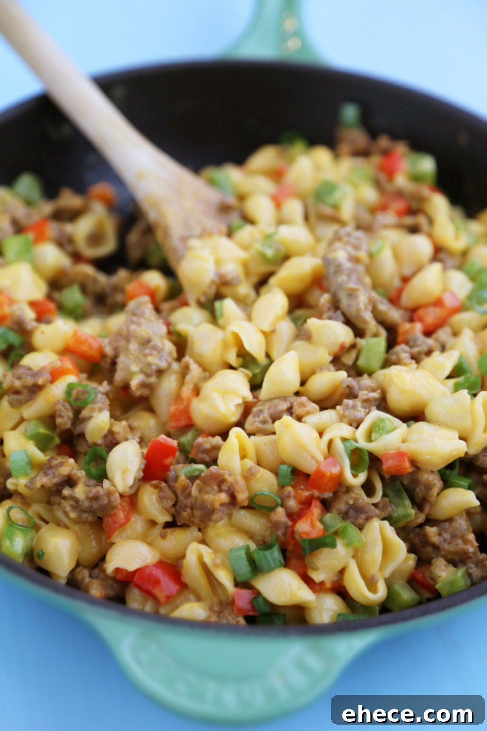 Overhead shot of Spicy Sausage and Bell Pepper Mac and Cheese in a large skillet, freshly cooked.