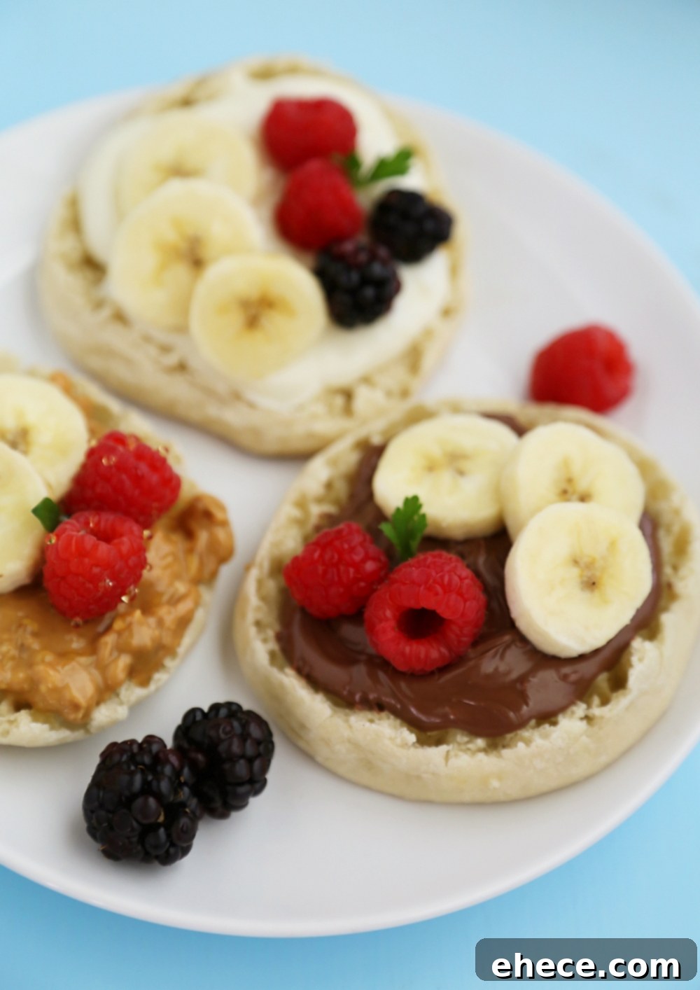English Muffin Fruit Breakfast Pizzas - Spread with yogurt, Nutella or peanut butter and top with fresh fruit for a delicious morning treat! thecomfortofcooking.com