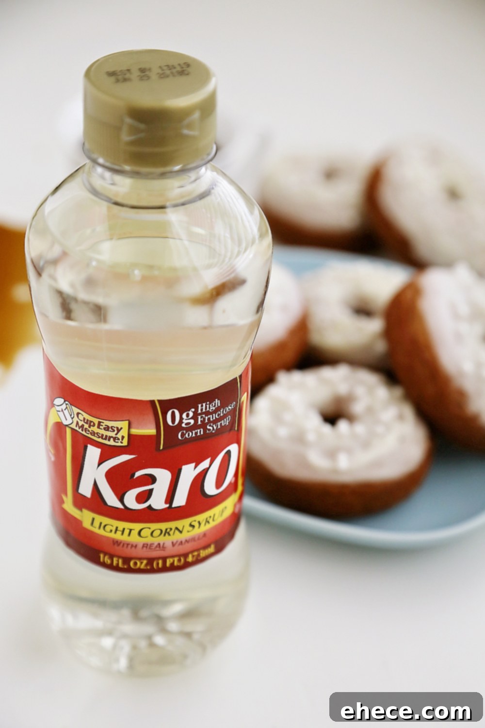 Pillowy Pumpkin Doughnuts with Dreamy Cream Cheese Frosting 4 Freshly baked pumpkin donuts cooling on a wire rack, ready for glazing.