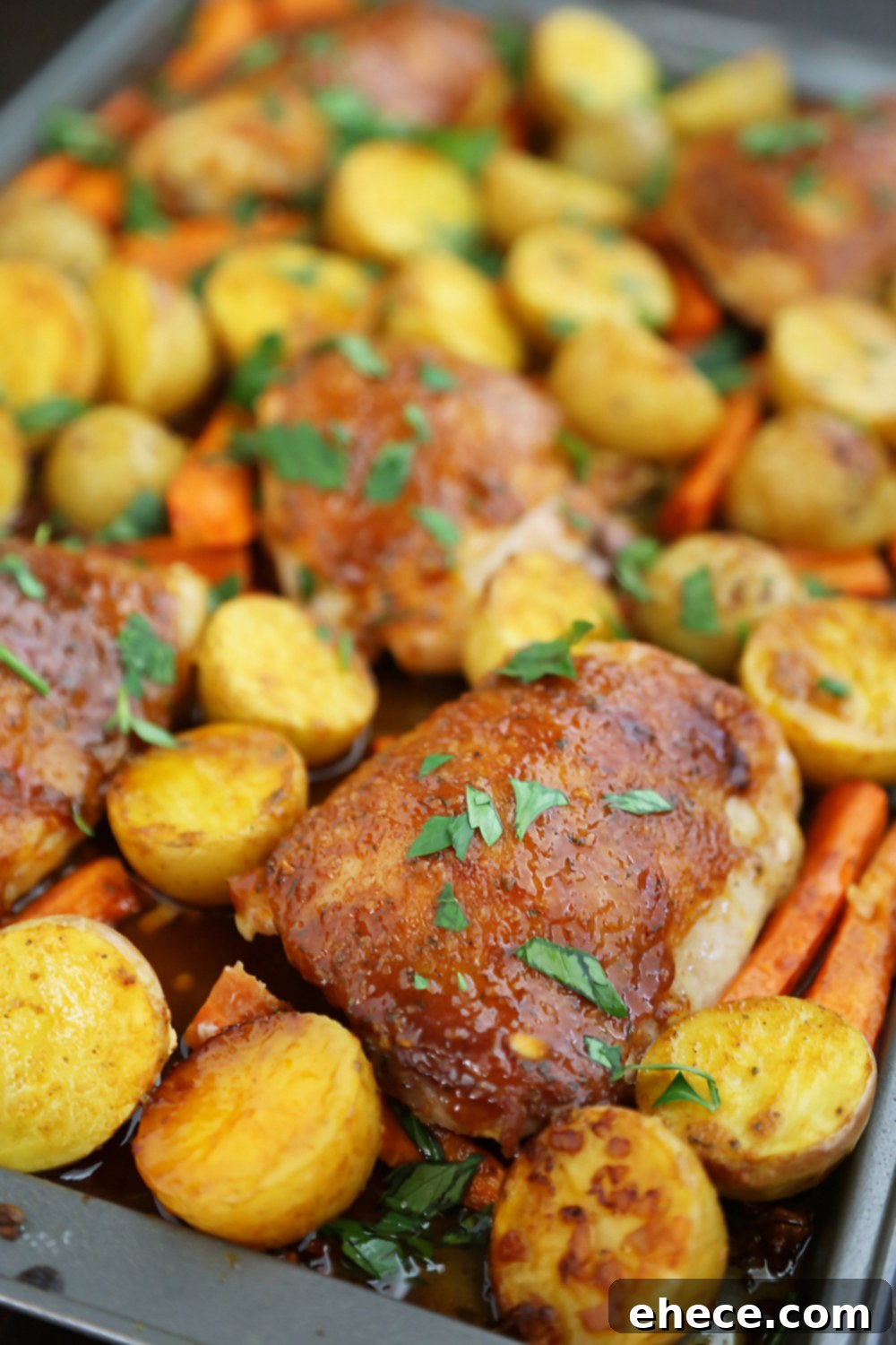 Sheet Pan Garlic Ranch Chicken and Roasted Vegetables 4 Assortment of ingredients for one-pan ranch chicken: raw chicken thighs, baby potatoes, baby carrots, and seasoning
