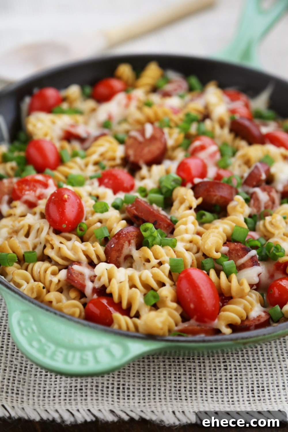 Cheesy Sausage and Tomato Pasta Skillet – This 15-minute dinner is so delicious and easy to whip up on weeknights! Thecomfortofcooking.com