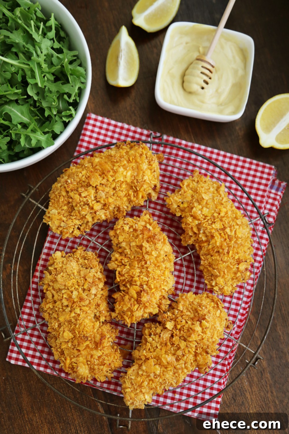 Crunchy Honey-Mustard Baked Chicken Strips 3 Crispy Honey-Dijon Baked Chicken Tenders - Cornflake crusted chicken with honey mustard dipping sauce (recipe included) makes a perfect weeknight meal that kids and adults will love! Thecomfortofcooking.com