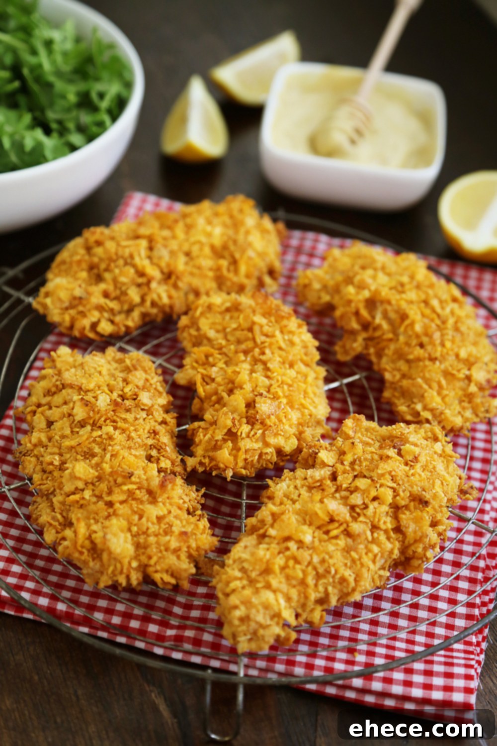 Crunchy Honey-Mustard Baked Chicken Strips 4 Crispy Honey-Dijon Baked Chicken Tenders - Cornflake crusted chicken with honey mustard dipping sauce (recipe included) makes a perfect weeknight meal that kids and adults will love! Thecomfortofcooking.com