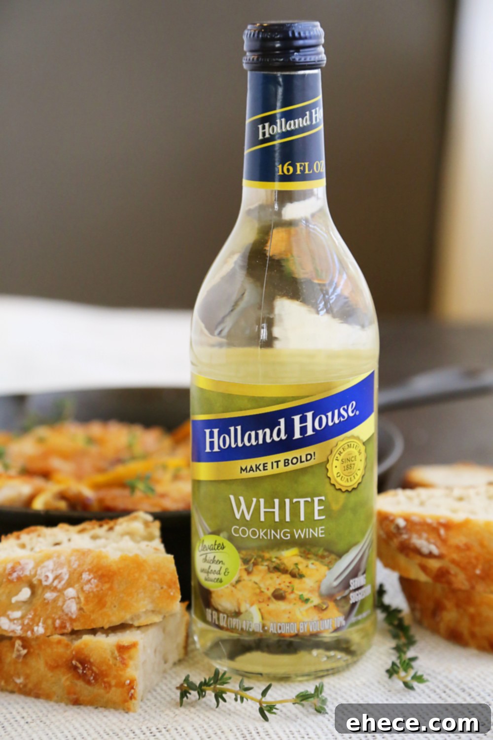 Skillet Crispy Lemon Chicken with White Wine Sauce - Close-up of golden crispy chicken thighs with lemon slices.