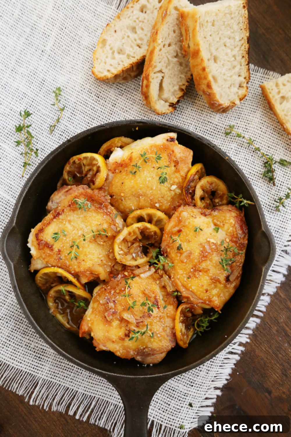 Skillet Crispy Lemon Chicken with White Wine Sauce - Plated and ready to enjoy with a side of bread.