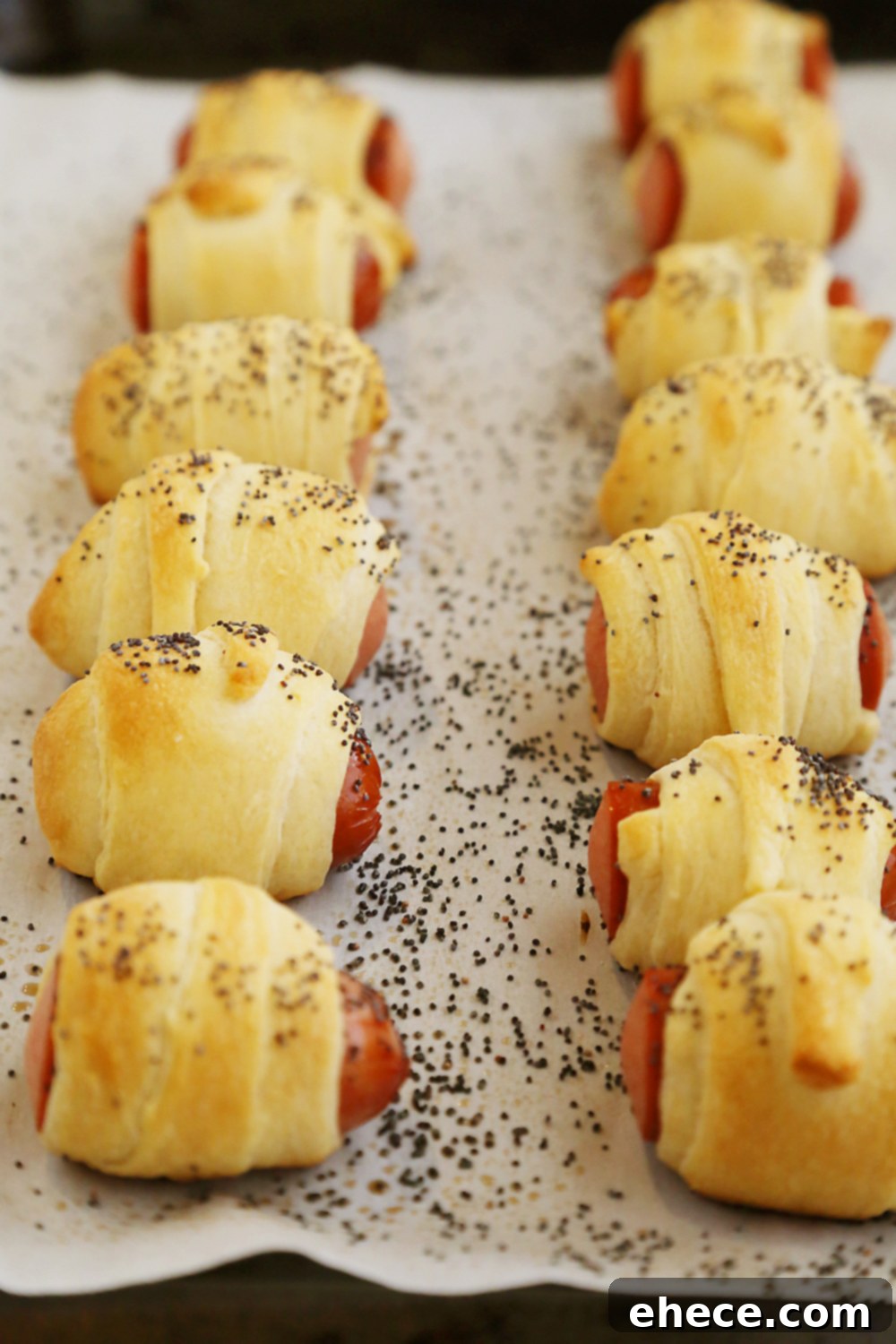 Delicious 3-Ingredient Crescent Hot Dog Rollups baking to golden perfection. Perfect for easy party food and kid-friendly snacks.