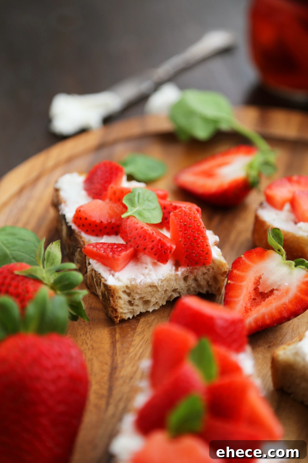Finished Vanilla Bean Pickled Strawberries with Goat Cheese Crostini on a wooden board - A perfect appetizer for entertaining. Thecomfortofcooking.com