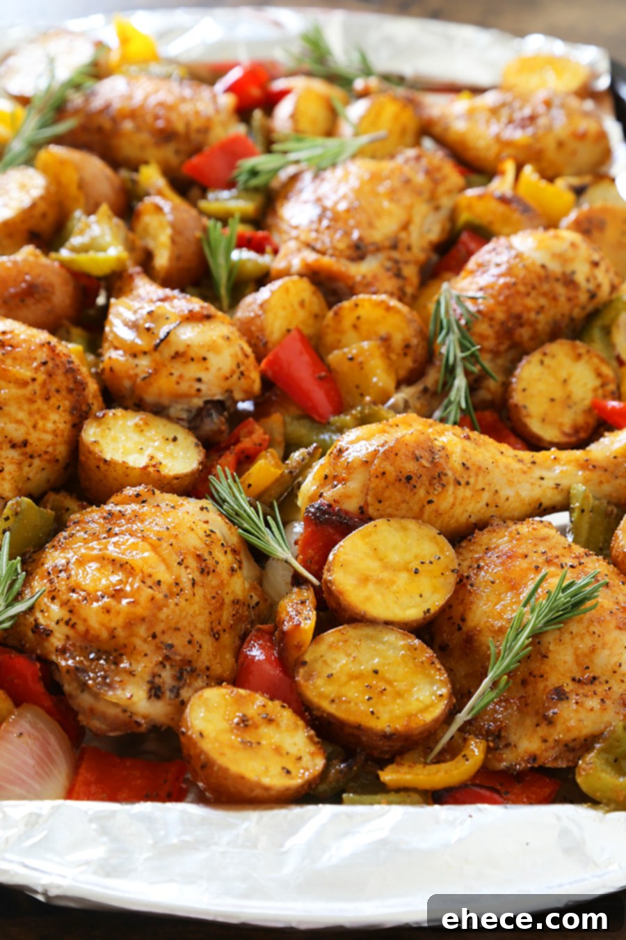 Rosemary Roasted Chicken with Bell Peppers and Potatoes - Crispy, tender roasted chicken with bell peppers, potatoes and onions makes an easy one-pan weeknight meal! TheComfortOfCooking.com