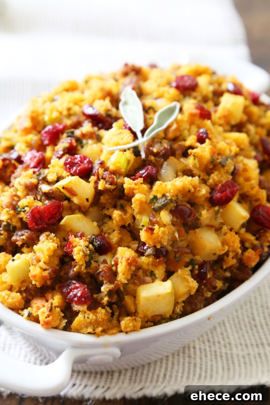 Full spread of Thanksgiving table with Sausage, Apple, and Cranberry Cornbread Stuffing as a prominent side.