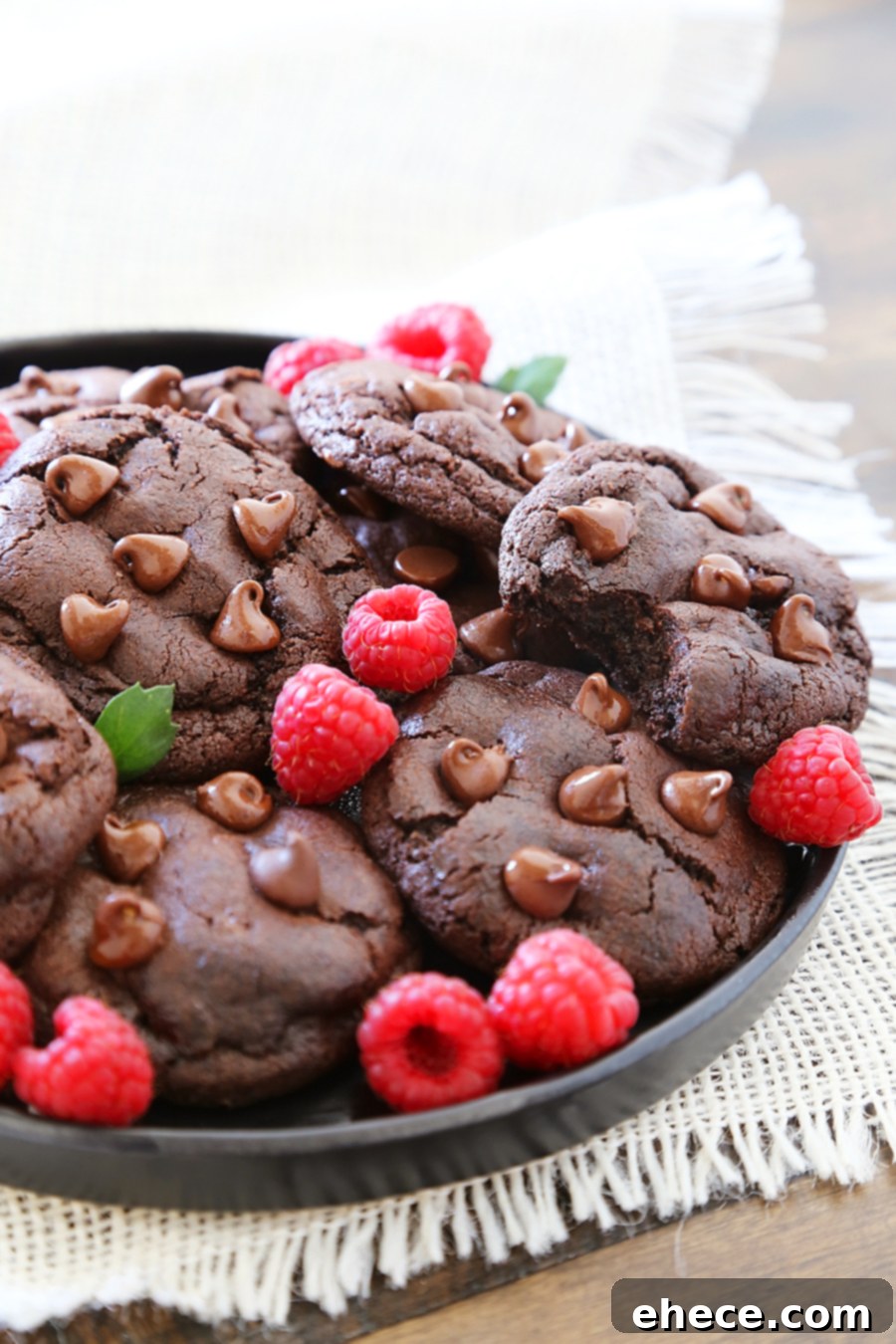 Pile of gooey double chocolate cookies with melted chocolate chips, highlighting their rich flavor and irresistible texture.