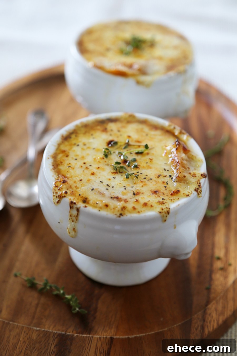 Easy French Onion Soup - Fragrant, cheesy and so comforting! Caramelized onions, beef stock and white (or red) cooking wine mingle into a luxurious medley in this classic French dish.