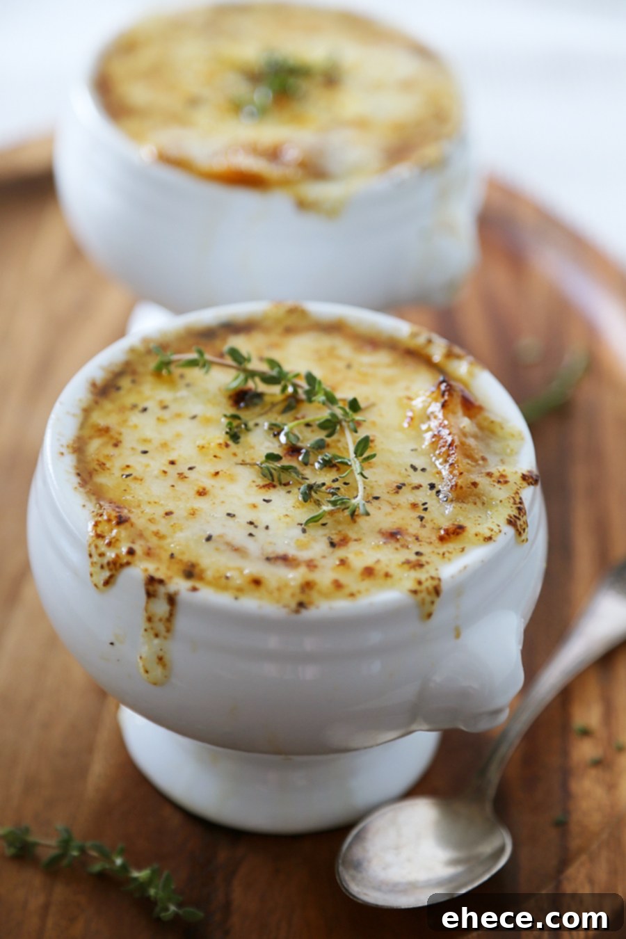 Easy French Onion Soup - Fragrant, cheesy and so comforting! Caramelized onions, beef stock and white (or red) cooking wine mingle into a luxurious medley in this classic French dish.