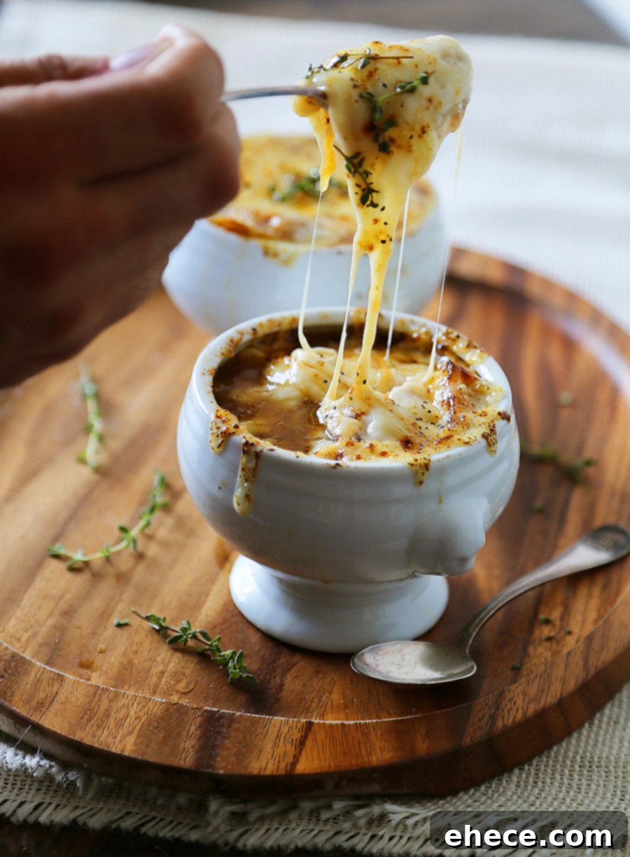 Easy French Onion Soup - Fragrant, cheesy and so comforting! Caramelized onions, beef stock and white (or red) cooking wine mingle into a luxurious medley in this classic French dish.