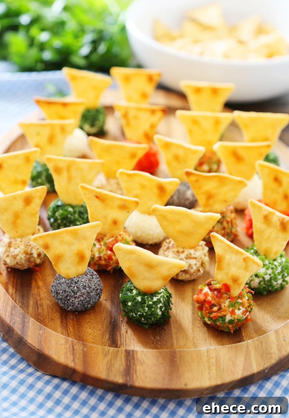 3-Ingredient Mini Queso Cheese Balls - The BEST quick and easy appetizer! Roll in chives, bacon, jalapeno, cranberries, nuts or veggies + top with pita chips! Thecomfortofcooking.com