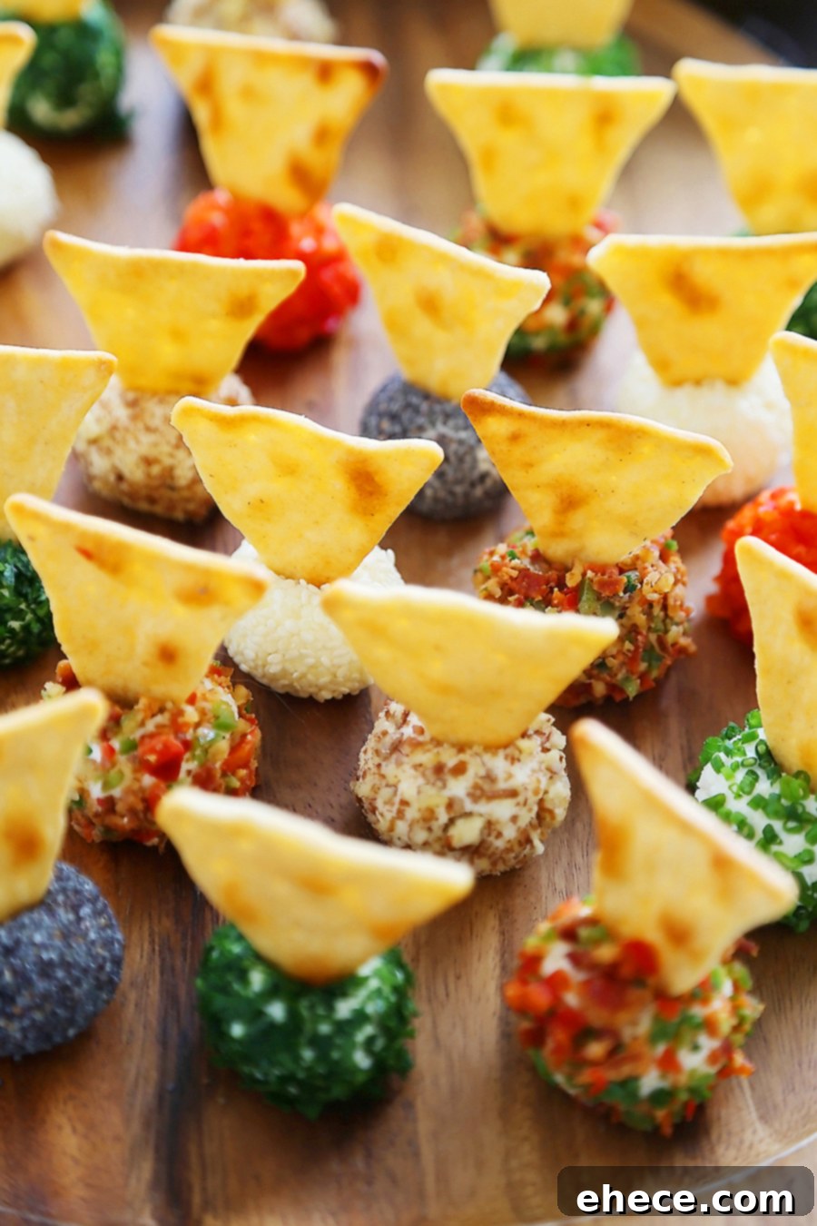 3-Ingredient Mini Queso Cheese Balls - The BEST quick and easy appetizer! Roll in chives, bacon, jalapeno, cranberries, nuts or veggies + top with pita chips! Thecomfortofcooking.com