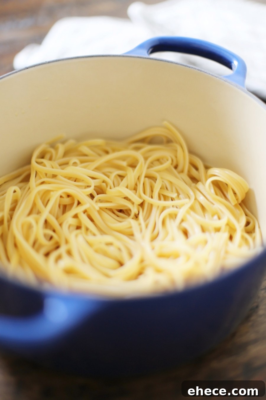 Close-up of butter roasted tomato sauce with linguine, garnished with fresh basil