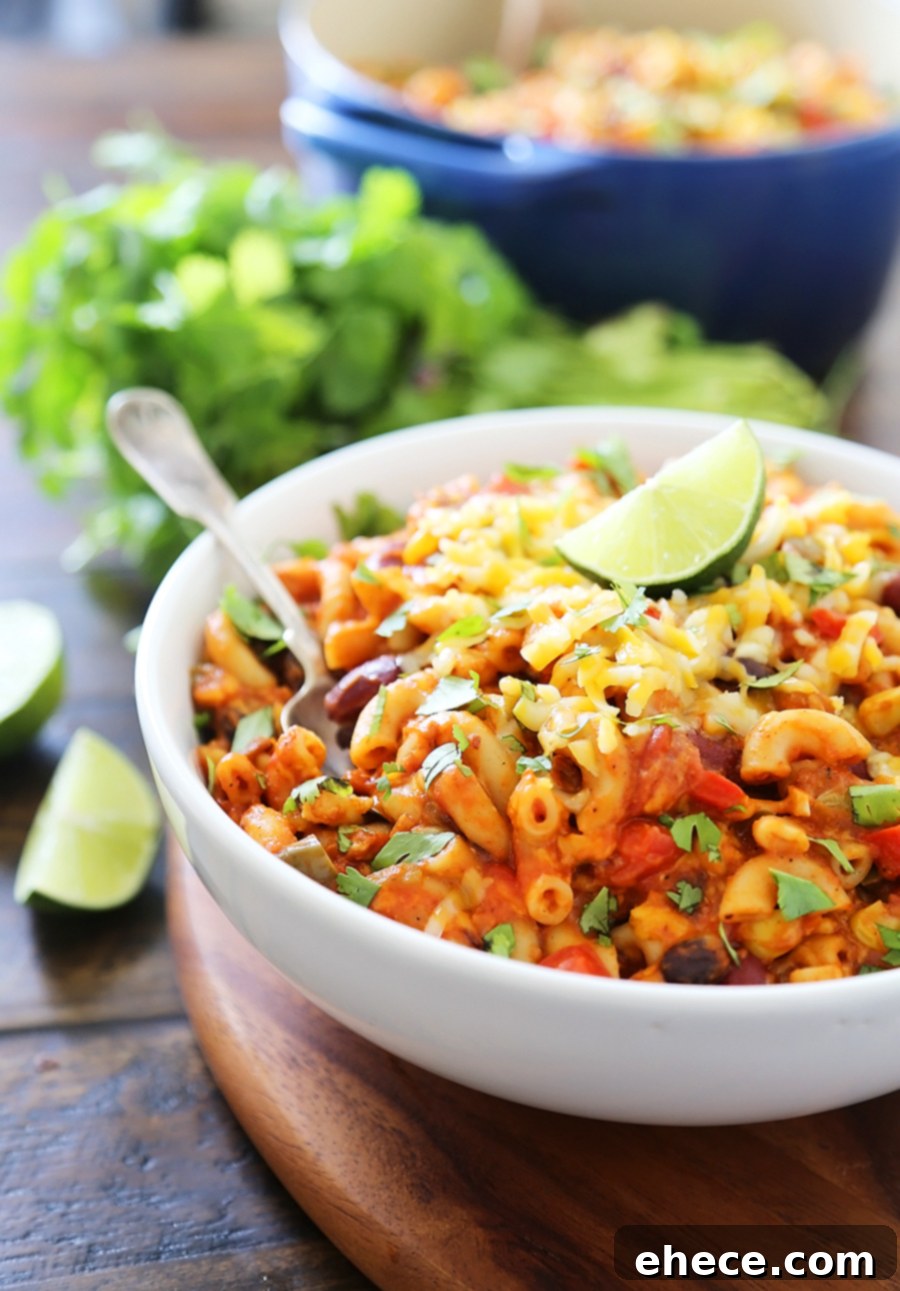 Hearty One-Pot Vegetarian Chili Mac and Cheese 7 One-Pot Cheesy Vegetarian Chili Mac 'n Cheese - Super cheesy, comforting and easy to make for meatless weeknights with family! Full of fresh veggies, beans, tomatoes and tender pasta! Thecomfortofcooking.com
