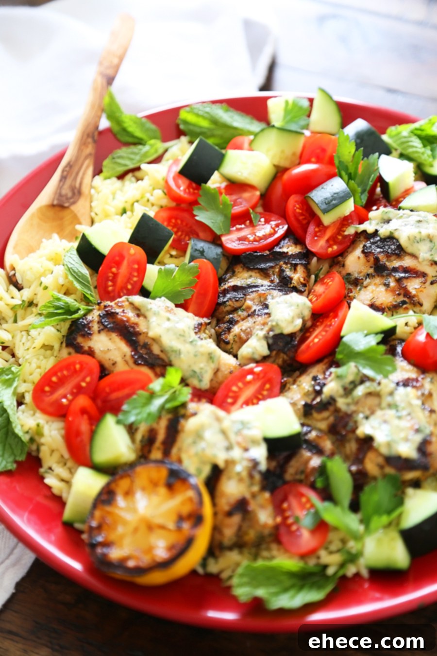 Greek Tahini Chicken with Cucumber, Tomato and Lemon Orzo Salad - Smoky, tender marinated chicken thighs with a creamy tahini sauce, fresh veggies, orzo and a squeeze of lemon! Full of nutritious, hearty goodness! Thecomfortofcooking.com