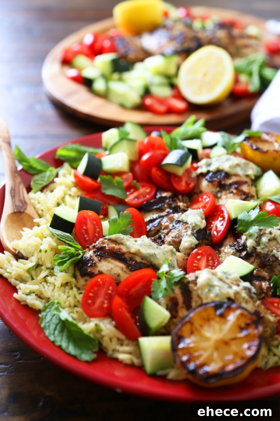 Greek Tahini Chicken with Cucumber, Tomato and Lemon Orzo Salad - Smoky, tender marinated chicken thighs with a creamy tahini sauce, fresh veggies, orzo and a squeeze of lemon! Full of nutritious, hearty goodness! Thecomfortofcooking.com