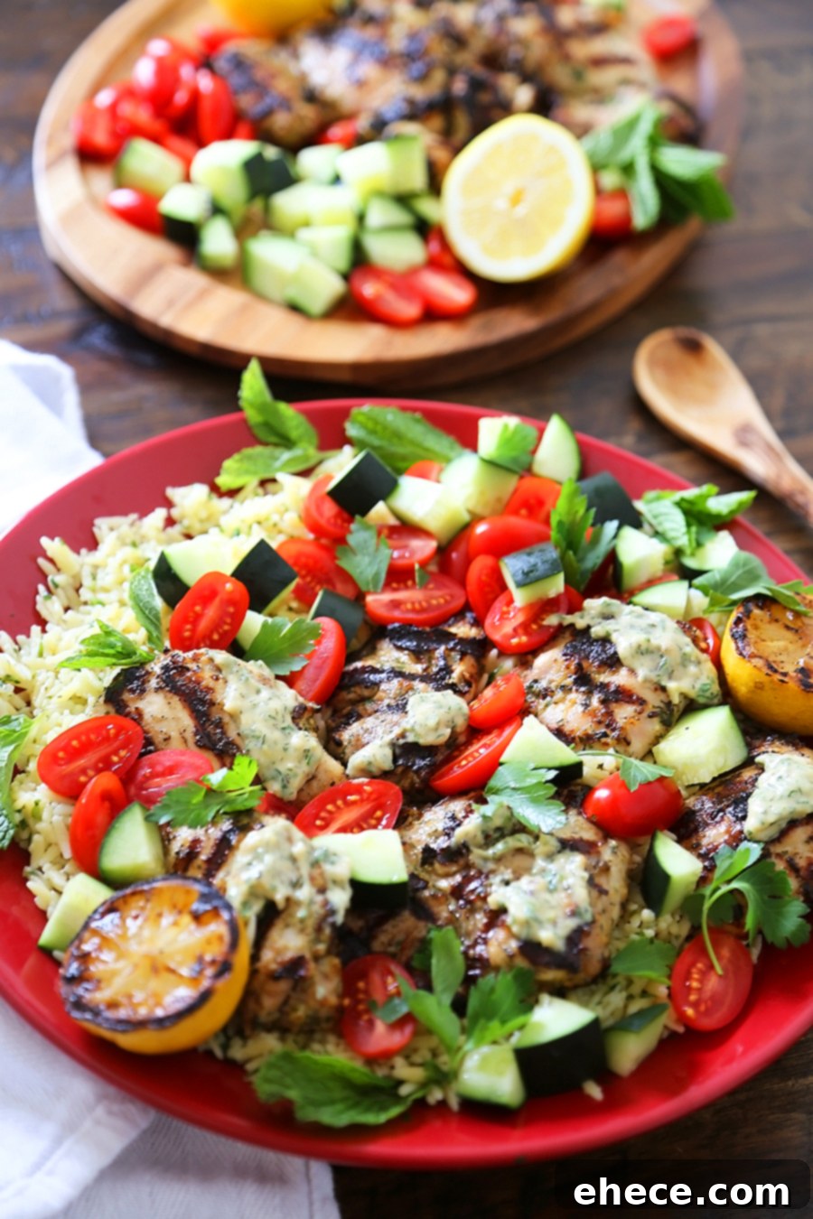 Greek Tahini Chicken with Cucumber, Tomato and Lemon Orzo Salad - Smoky, tender marinated chicken thighs with a creamy tahini sauce, fresh veggies, orzo and a squeeze of lemon! Full of nutritious, hearty goodness! Thecomfortofcooking.com