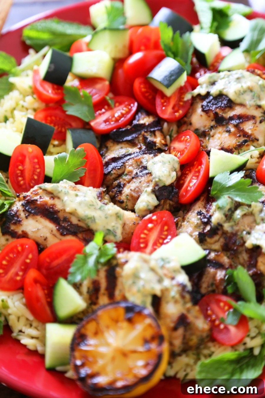 Greek Tahini Chicken with Cucumber, Tomato and Lemon Orzo Salad - Smoky, tender marinated chicken thighs with a creamy tahini sauce, fresh veggies, orzo and a squeeze of lemon! Full of nutritious, hearty goodness! Thecomfortofcooking.com