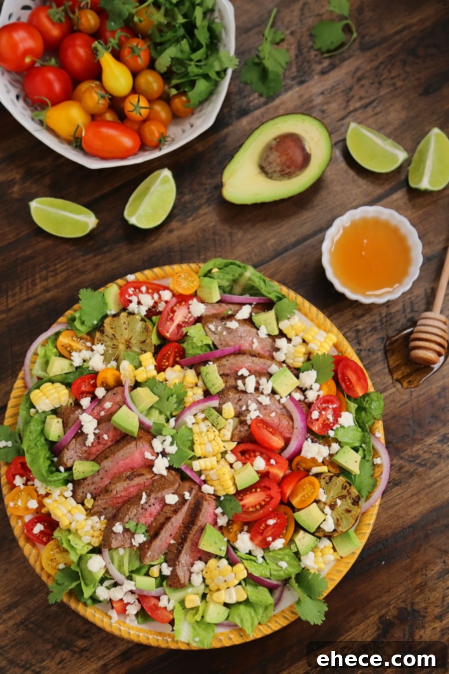Mexican Grilled Steak Salad with Honey Lime Dressing - Smoky, spicy steak, fresh corn, red onions, creamy avocado and a zesty honey lime dressing. Full of flavor, color and nutritious goodness! Thecomfortofcooking.com