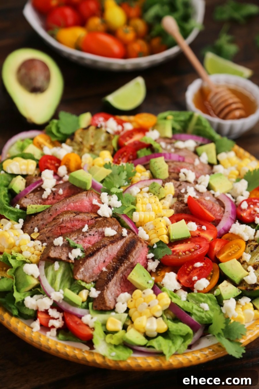 Mexican Grilled Steak Salad with Honey Lime Dressing - Smoky, spicy steak, fresh corn, red onions, creamy avocado and a zesty honey lime dressing. Full of flavor, color and nutritious goodness! Thecomfortofcooking.com