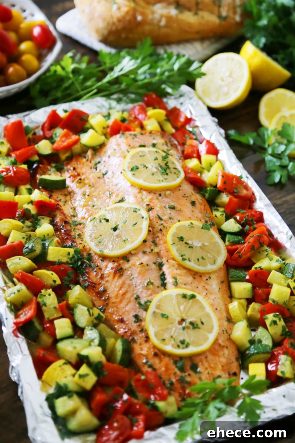 Lemon Garlic Honey Butter Salmon Veggie Foil Packs 2 Lemon-Garlic Honey Butter Salmon & Veggies in Foil - Juicy, flaky roasted salmon with lemon-garlic honey butter and tender summer veggies! One pan full of hearty, healthy goodness! thecomfortofcooking.com