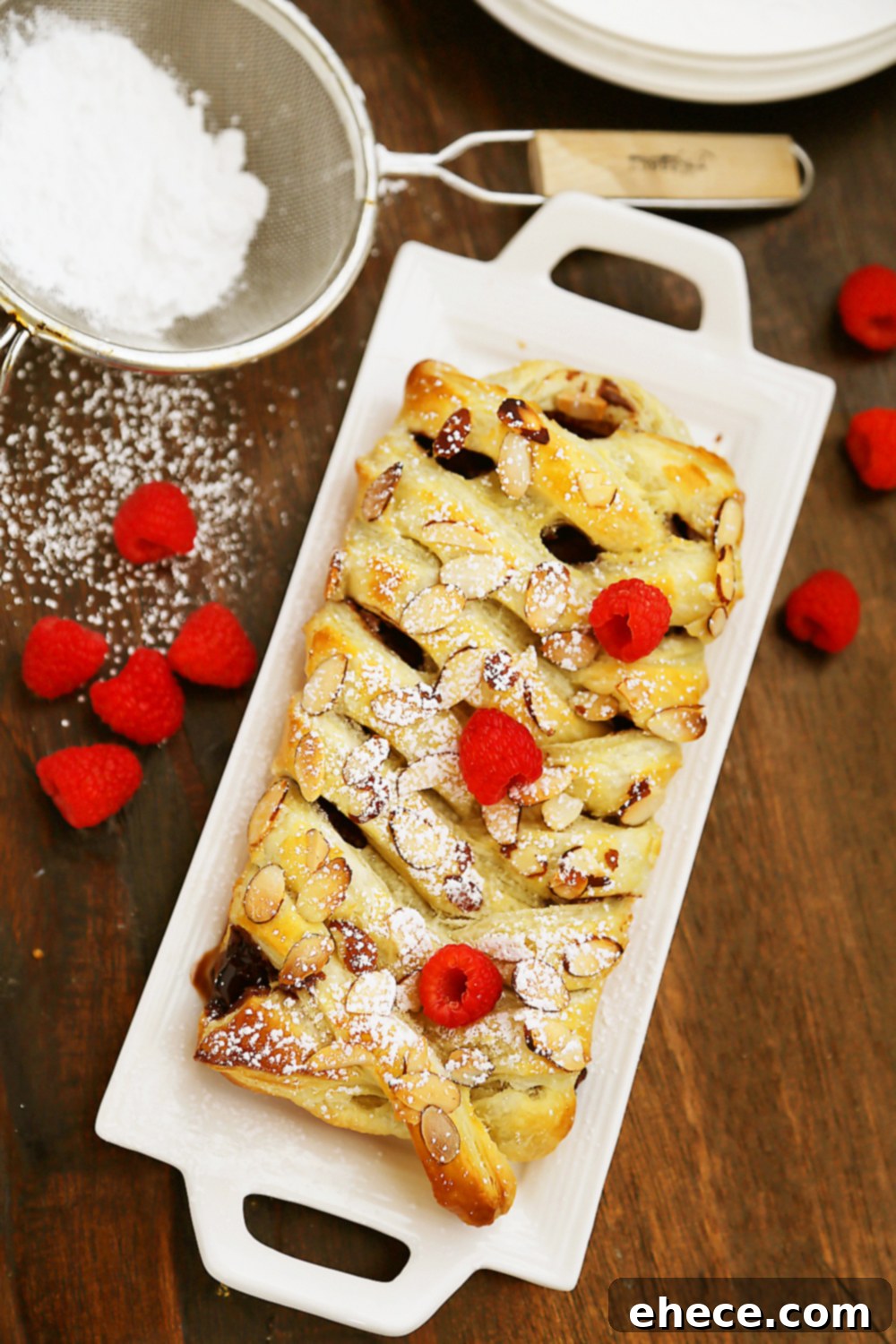 Further process shots showing the puff pastry strips being folded over the chocolate bar to create the braided effect.