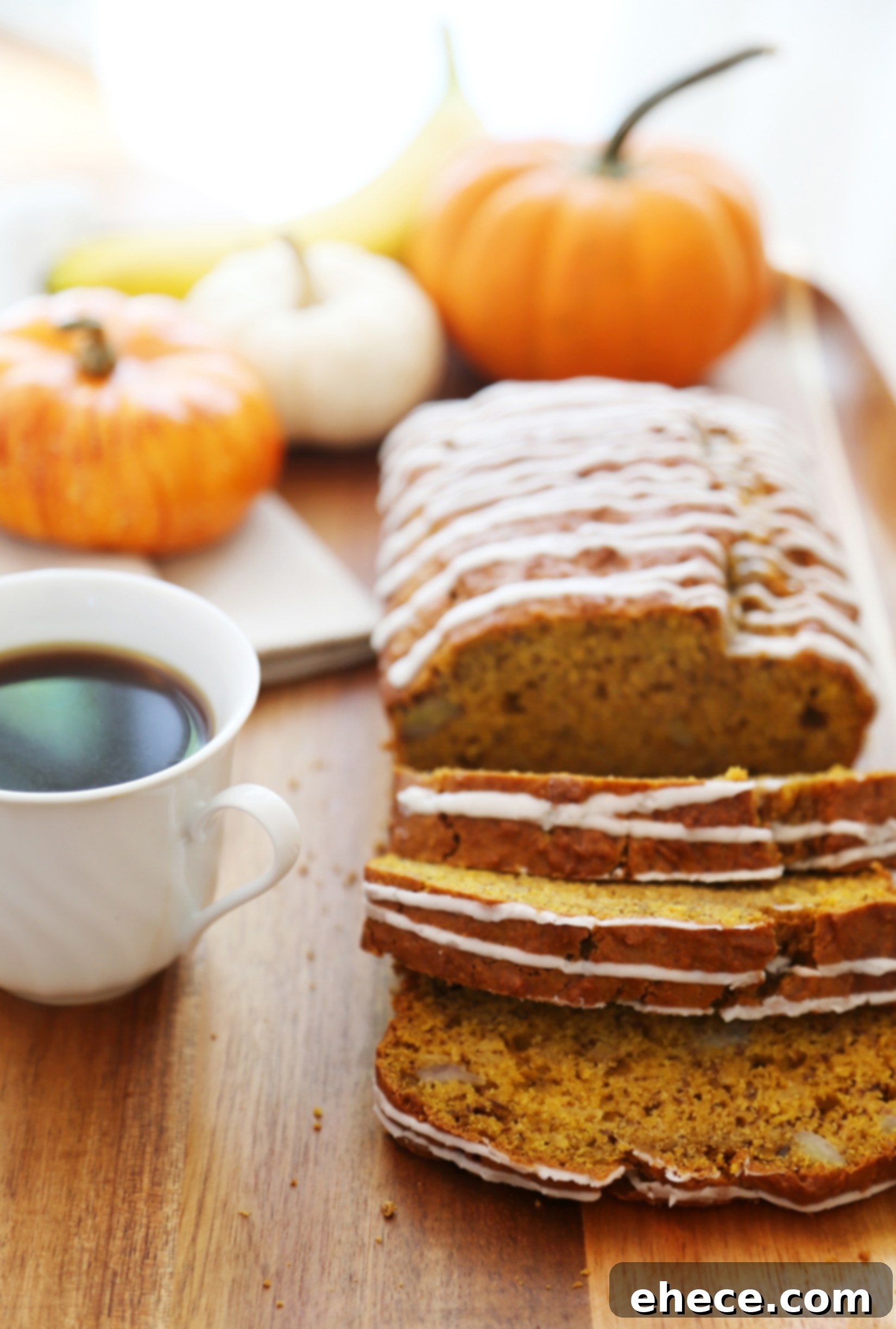 Autumn Pumpkin Banana Bread with Vanilla Drizzle 3 Slices of Pumpkin Banana Bread with Vanilla Glaze ready to serve, showcasing its moist texture and golden-brown crust.