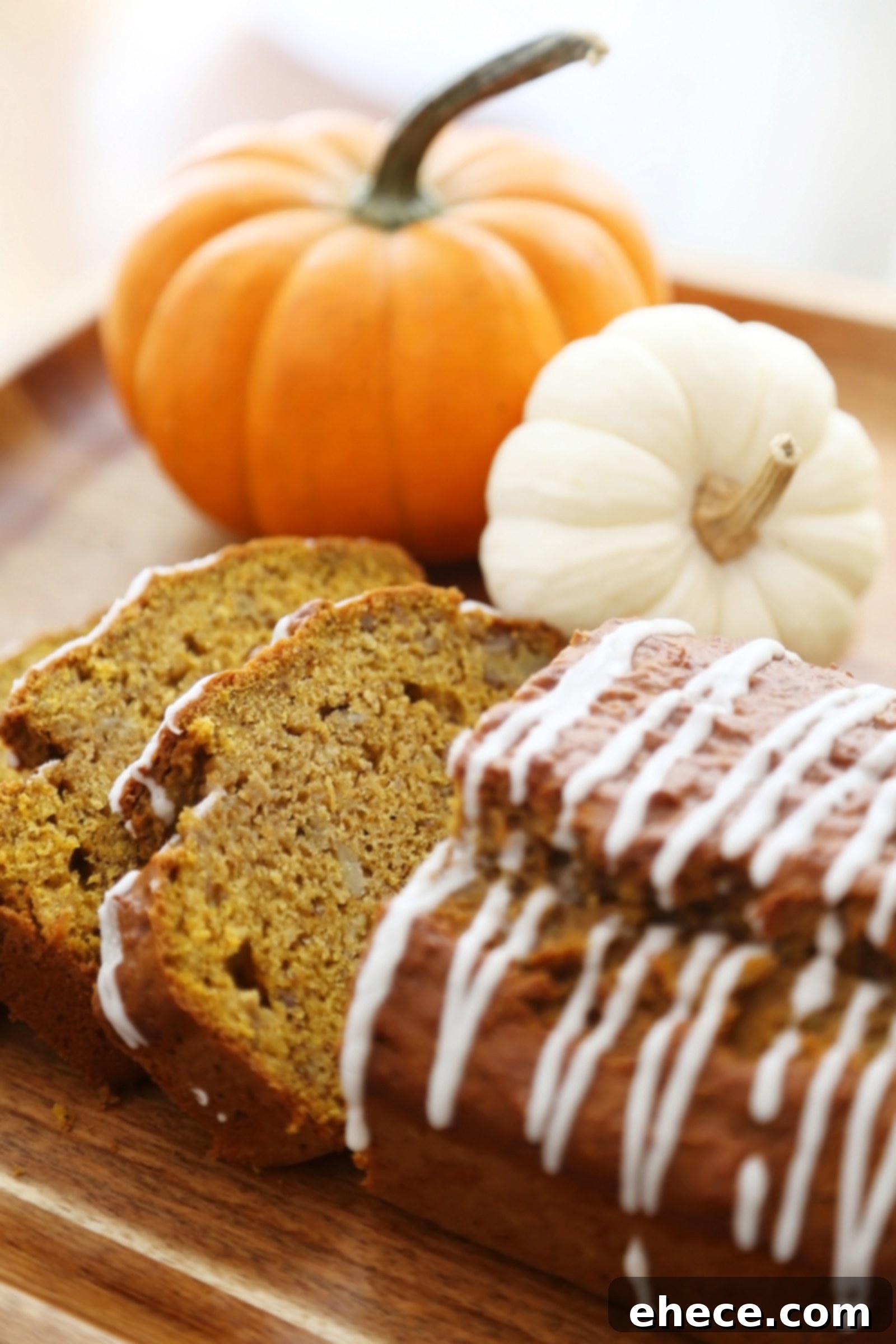 Autumn Pumpkin Banana Bread with Vanilla Drizzle 5 Overhead view of two loaves of Pumpkin Banana Bread, one whole and one sliced, with a creamy vanilla glaze.
