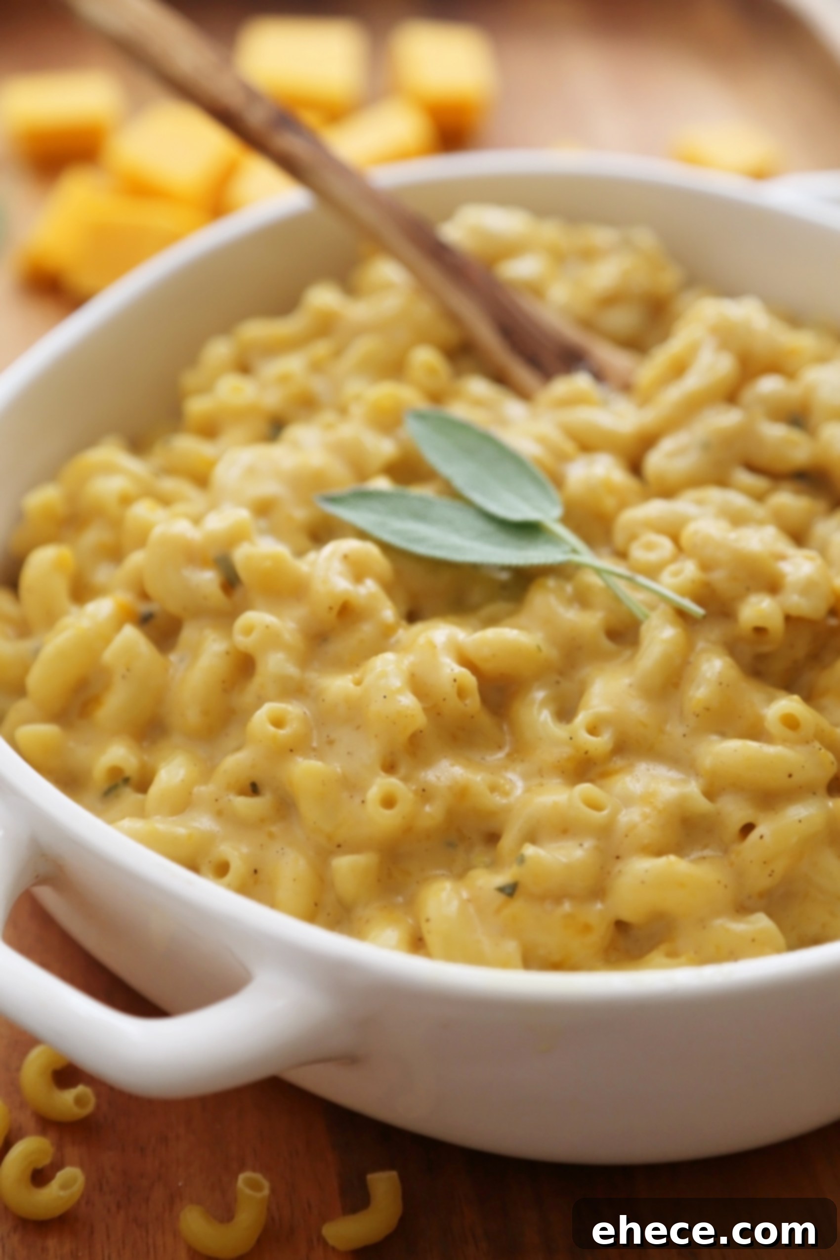 Close-up of golden, baked butternut squash mac and cheese with melted cheese pull