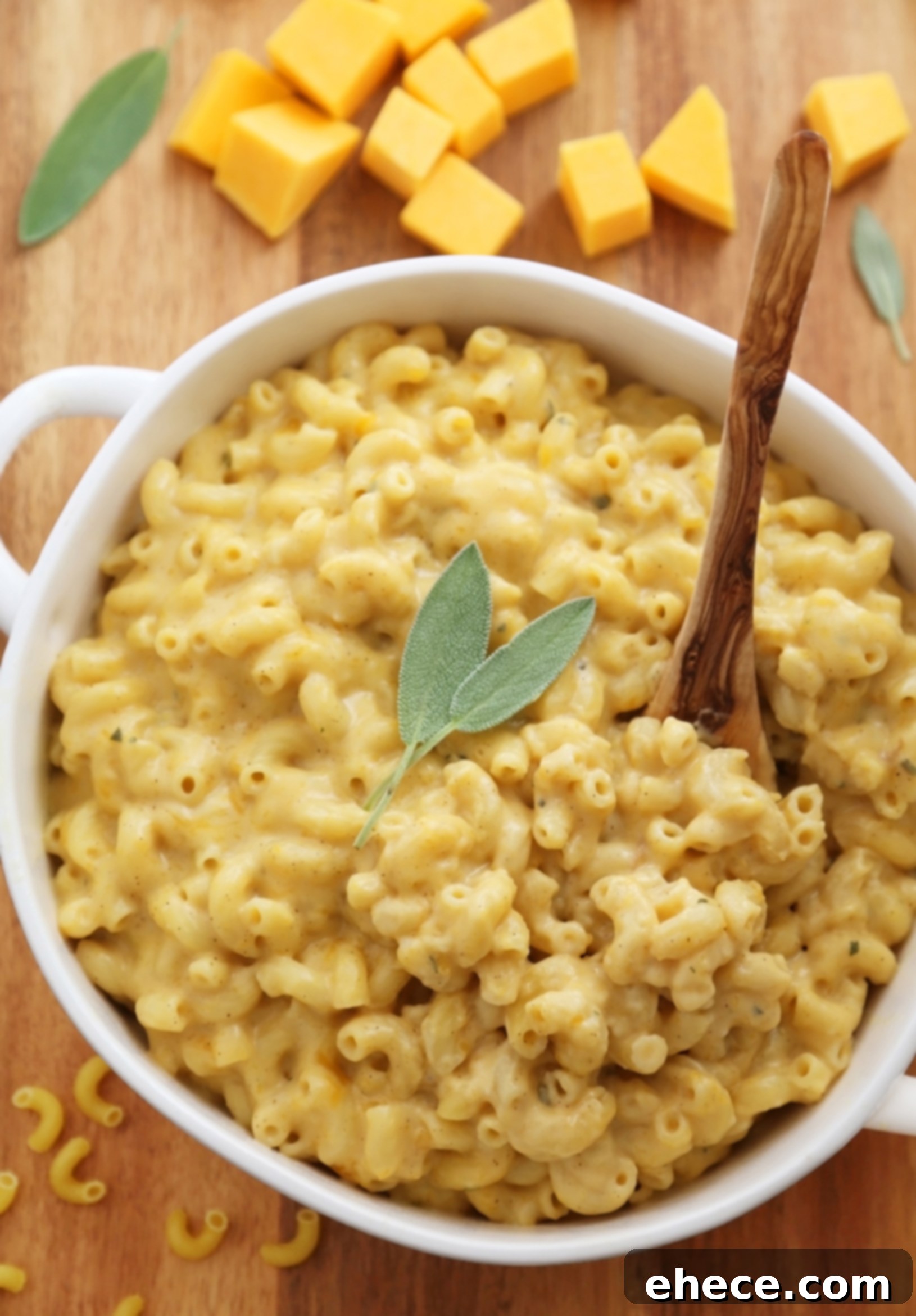 Butternut squash mac and cheese baking in a casserole dish, bubbling and golden