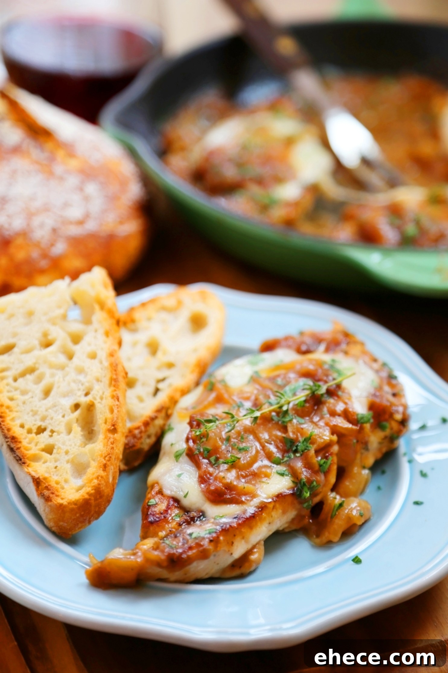 Skillet French Onion Chicken - Saucy, melt-in-your-mouth French onion chicken smothered in caramelized onion gravy, topped with melted cheese.