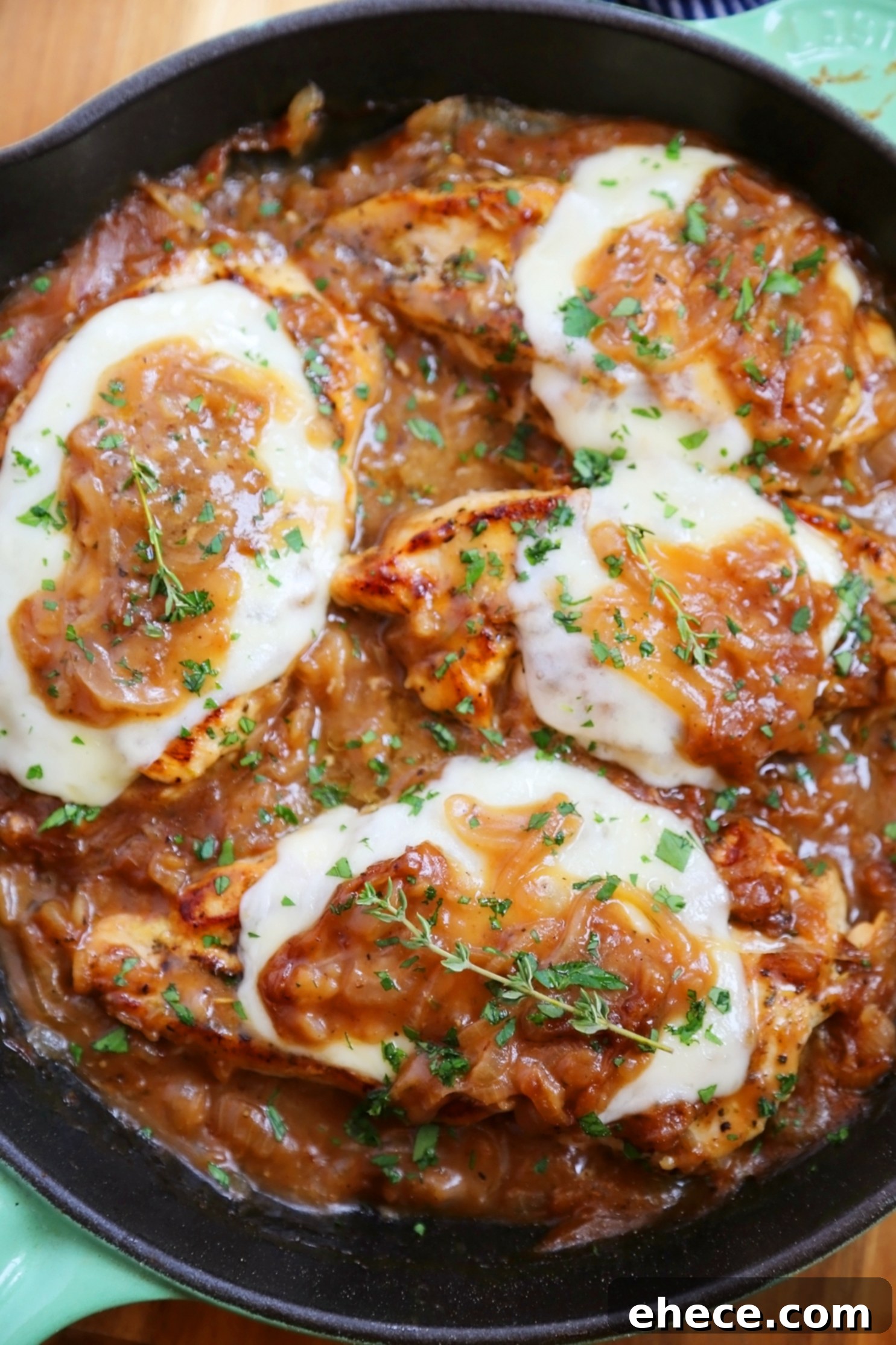 Skillet French Onion Chicken - Saucy, melt-in-your-mouth French onion chicken smothered in caramelized onion gravy, topped with melted cheese.
