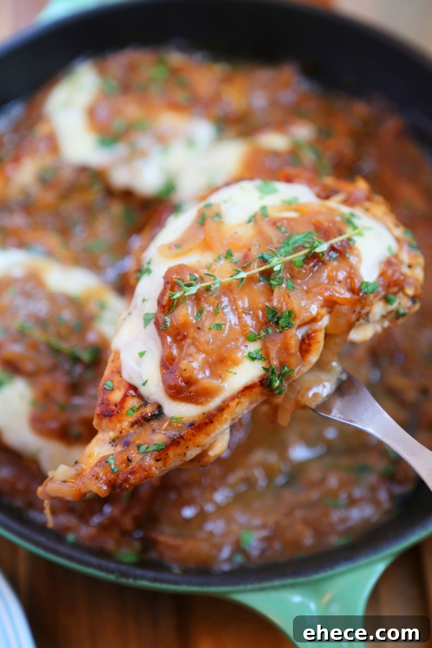 Skillet French Onion Chicken - Saucy, melt-in-your-mouth French onion chicken smothered in caramelized onion gravy, topped with melted cheese.