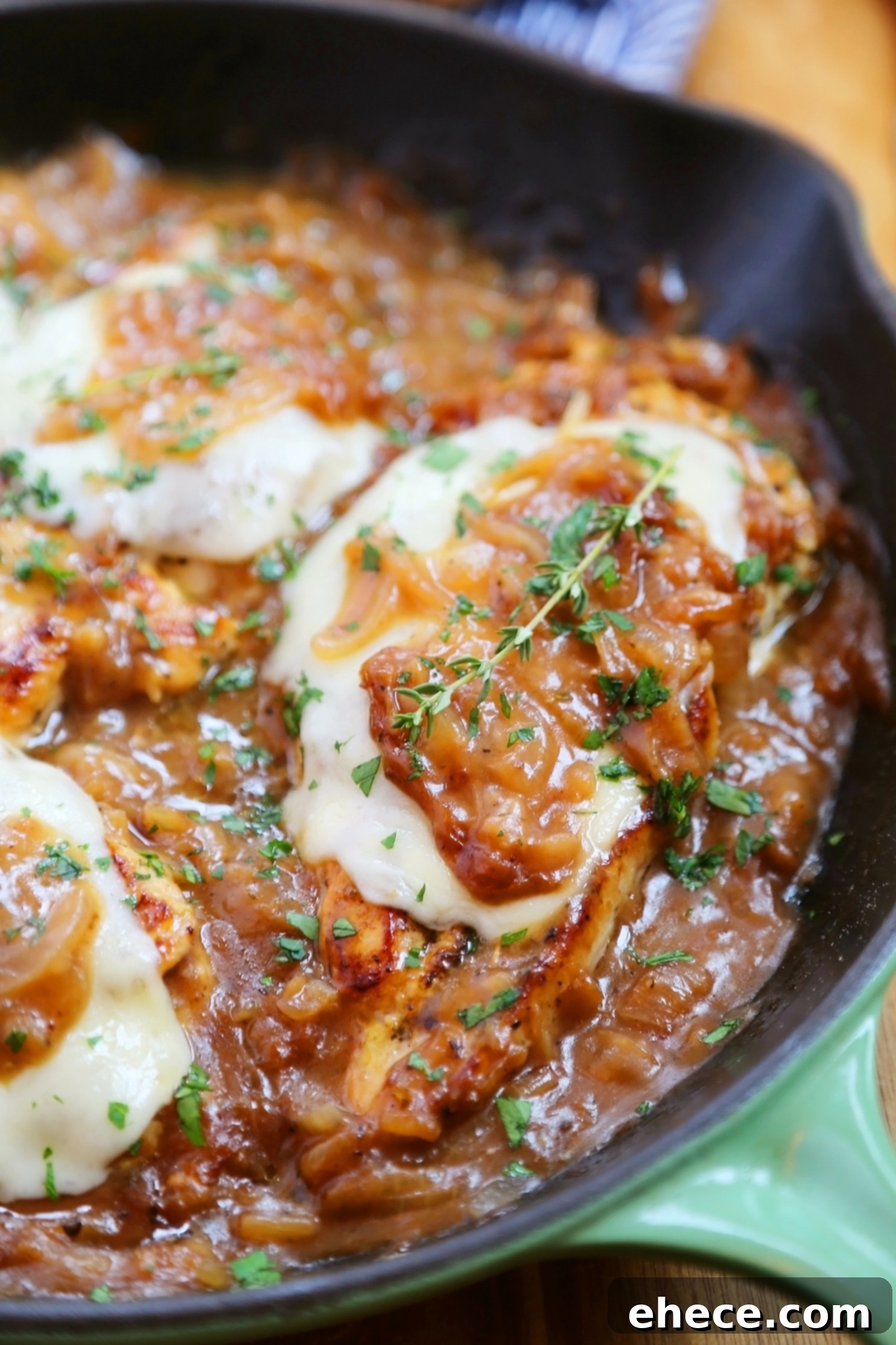 Skillet French Onion Chicken - Saucy, melt-in-your-mouth French onion chicken smothered in caramelized onion gravy, topped with melted cheese.