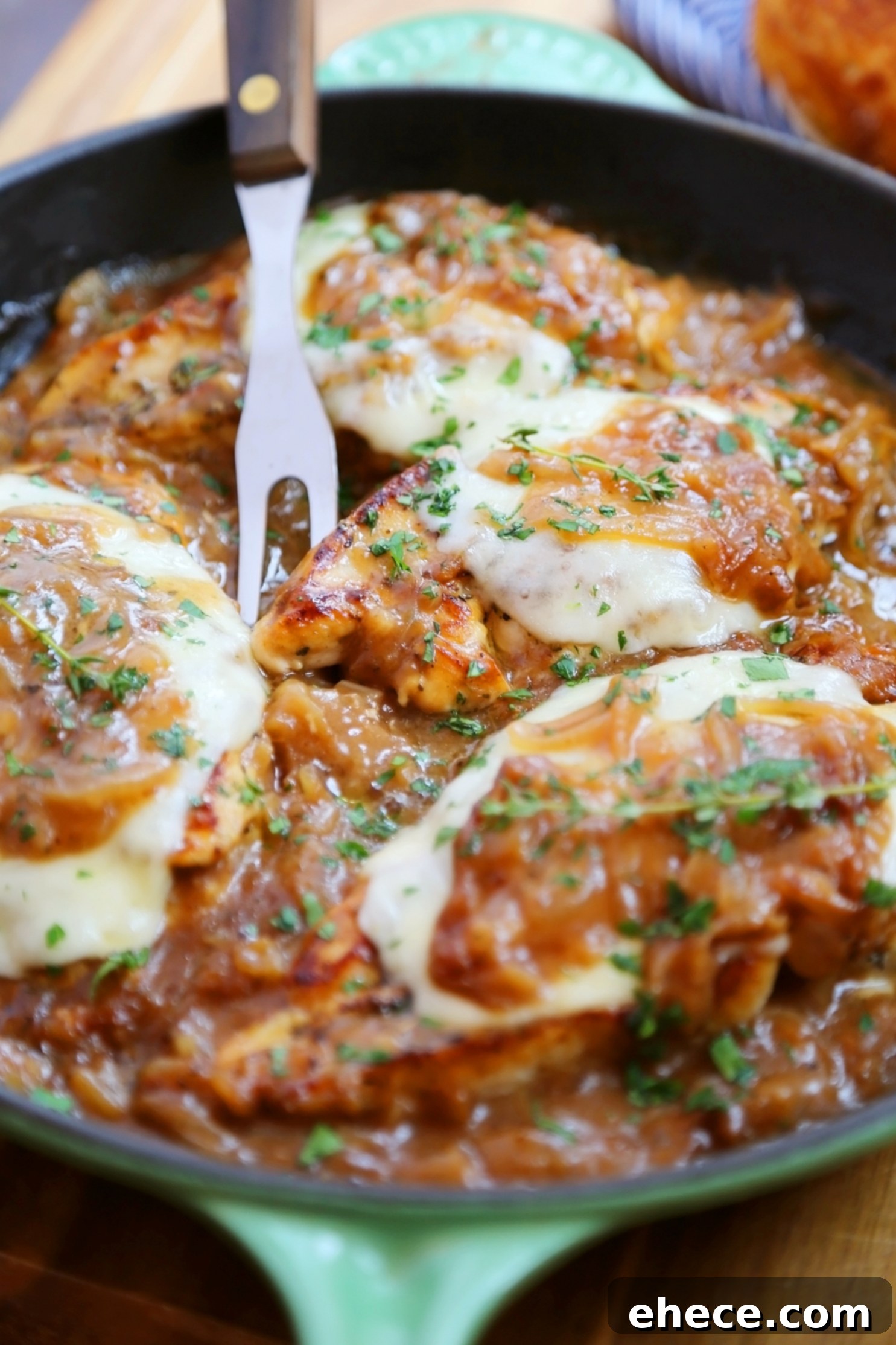 Skillet French Onion Chicken - Saucy, melt-in-your-mouth French onion chicken smothered in caramelized onion gravy, topped with melted cheese.