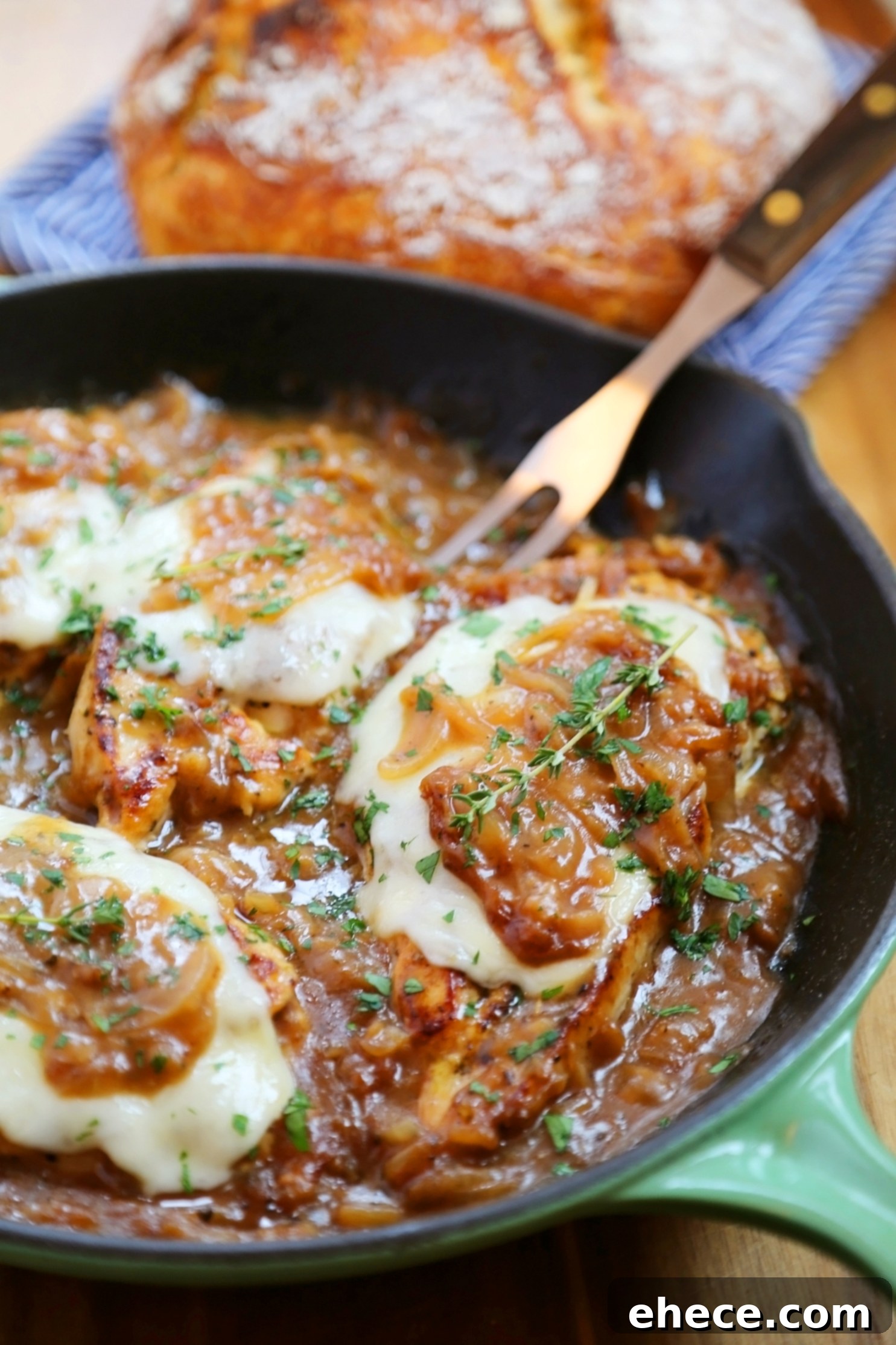 Skillet French Onion Chicken - Saucy, melt-in-your-mouth French onion chicken smothered in caramelized onion gravy, topped with melted cheese.