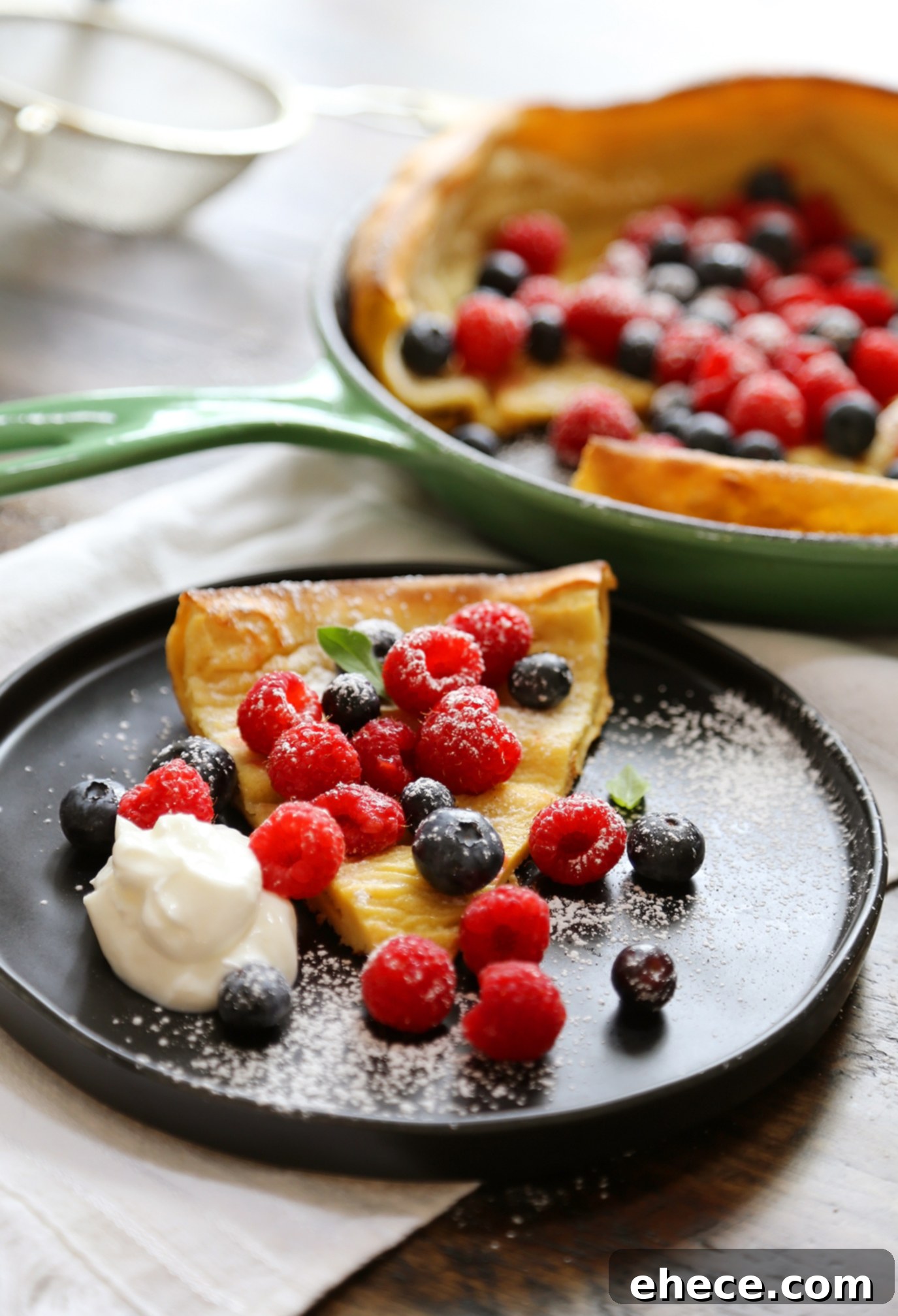 Dutch Baby Pancake topped with fresh fruit and powdered sugar