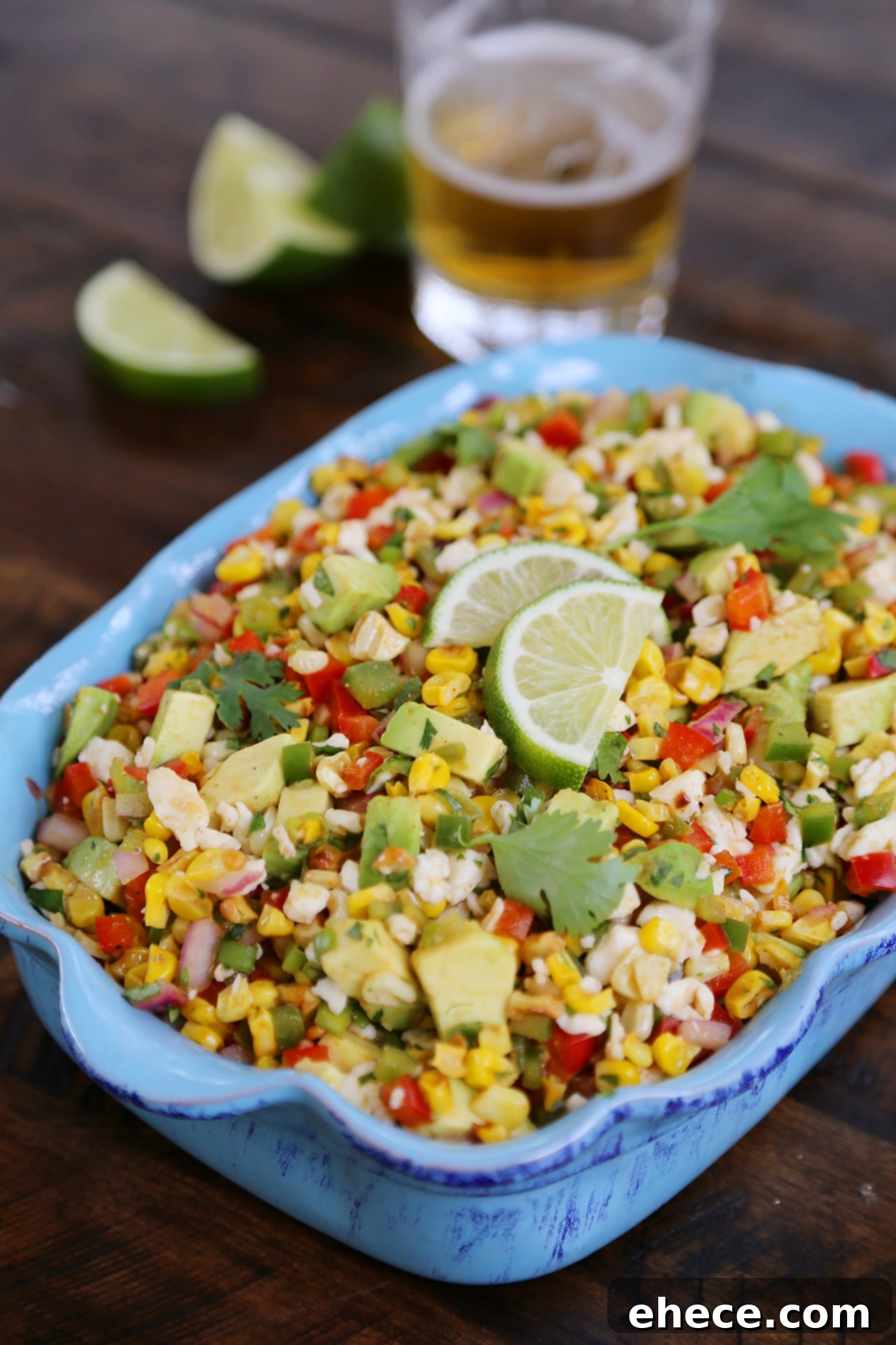 Mexican Street Corn Salad - A serving bowl filled with the colorful salad, ready to be enjoyed with tortilla chips.