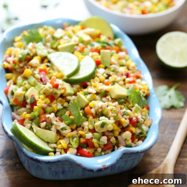 Mexican Street Corn Salad: A flavorful blend of charred corn, creamy avocado, and zesty lime, topped with Cotija cheese.