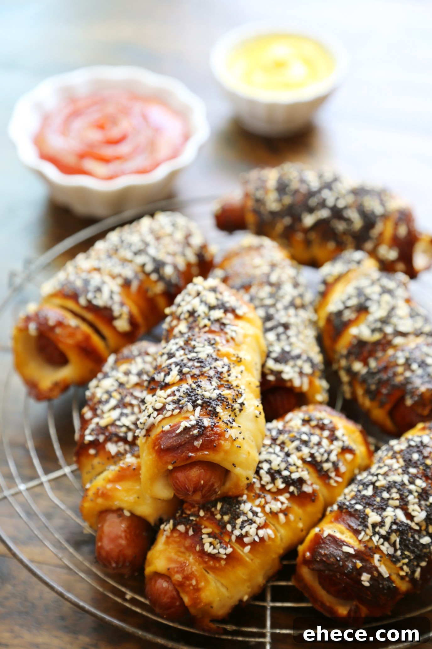 Two hands reaching for delicious pretzel dogs