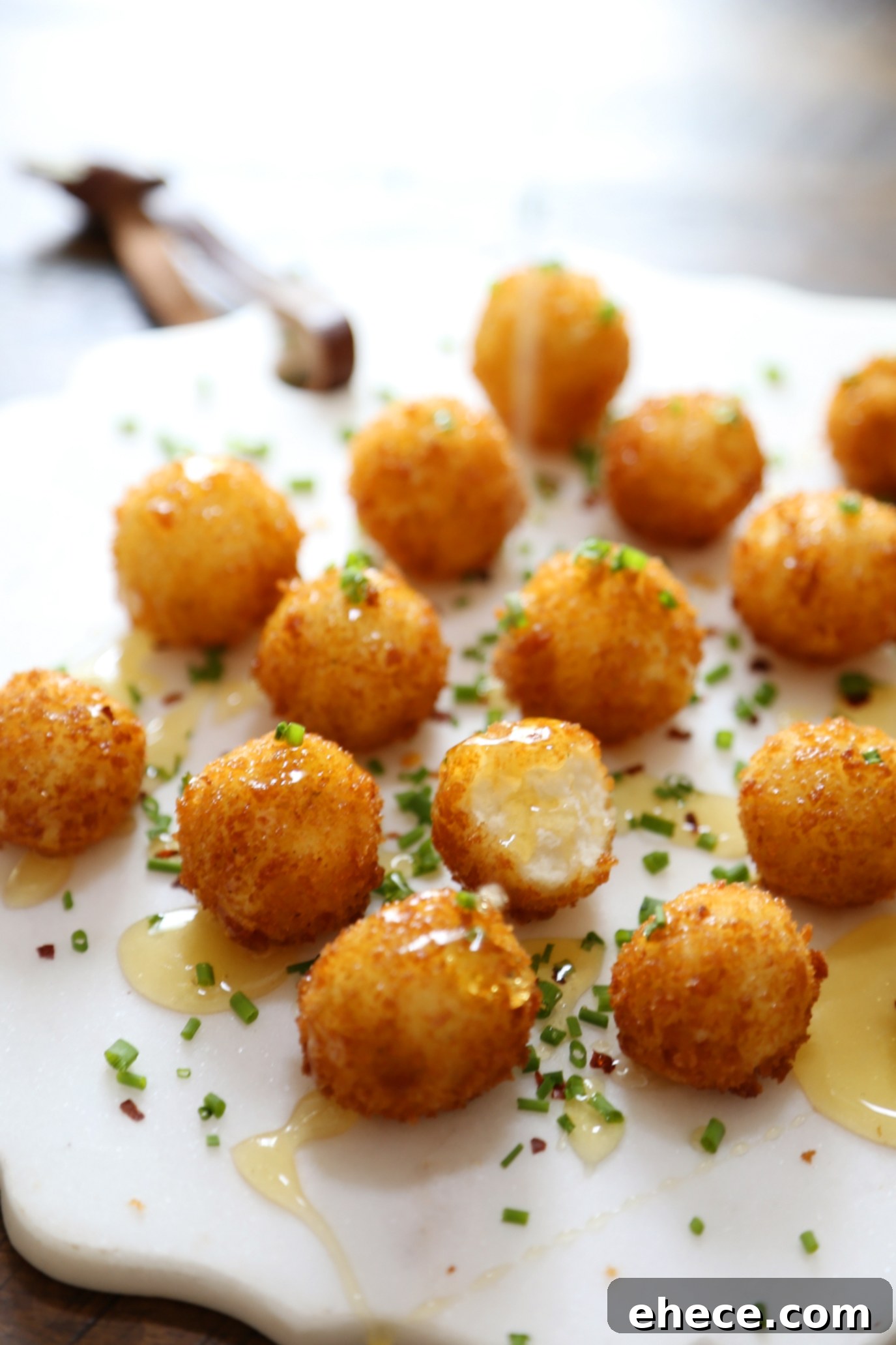 Crispy Goat Cheese Poppers with Honey - Creamy, melt-in-your-mouth bites of fried goat cheese perfection! thecomfortofcooking.com