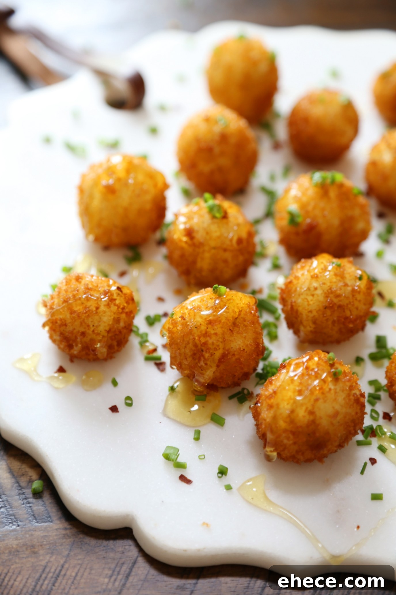 Crispy Goat Cheese Poppers with Honey - Creamy, melt-in-your-mouth bites of fried goat cheese perfection! thecomfortofcooking.com