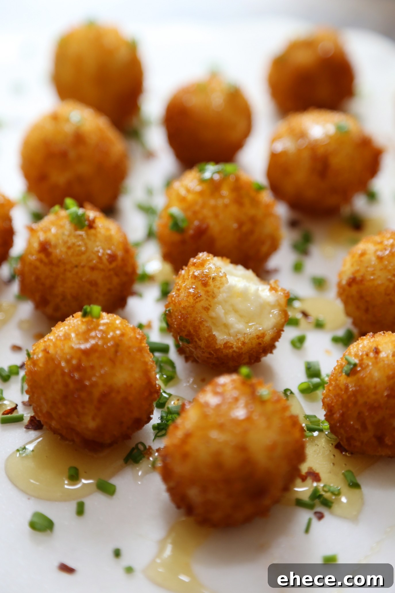 Crispy Goat Cheese Poppers with Honey - Creamy, melt-in-your-mouth bites of fried goat cheese perfection! thecomfortofcooking.com