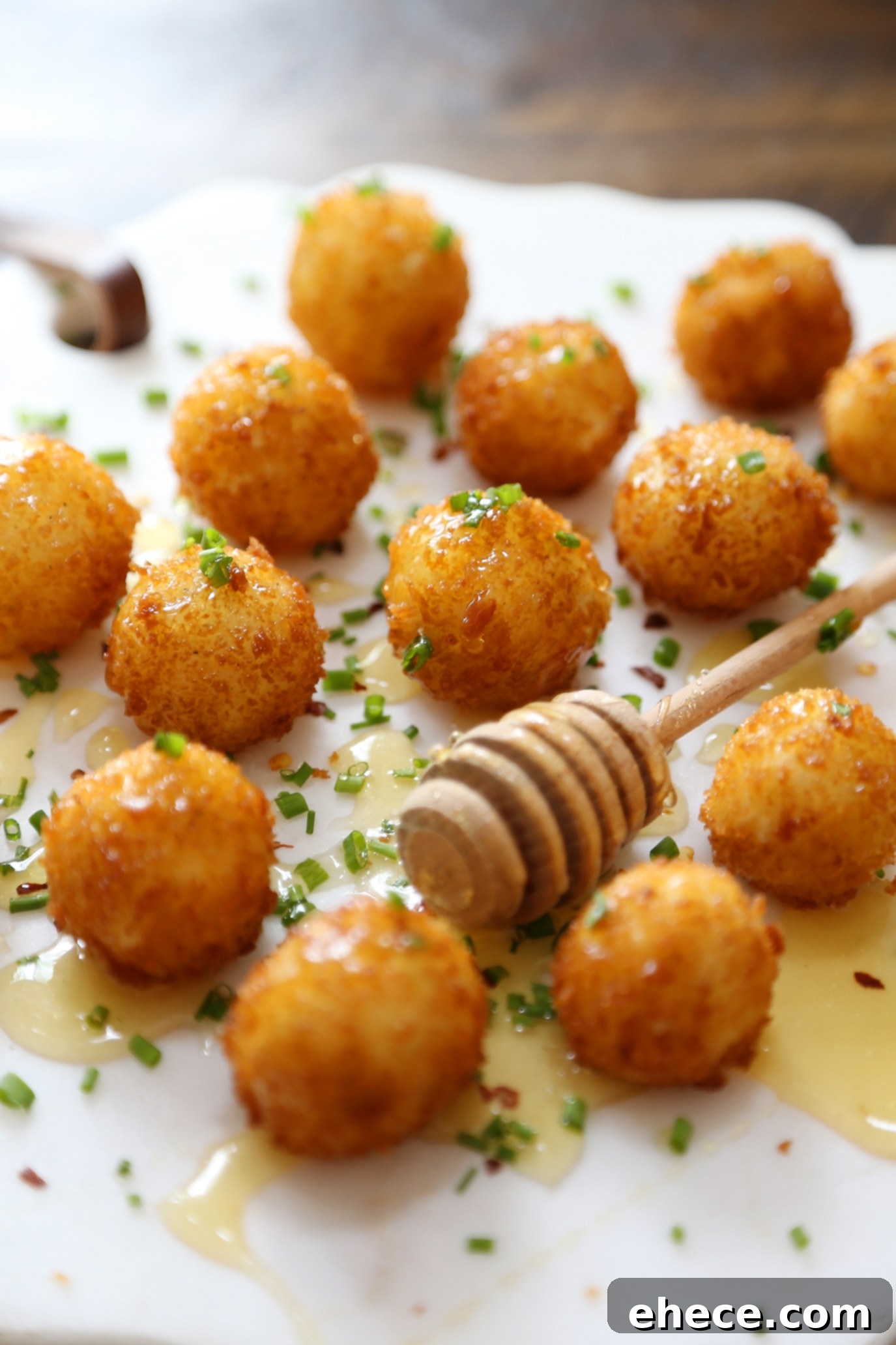 Crispy Goat Cheese Poppers with Honey - Creamy, melt-in-your-mouth bites of fried goat cheese perfection! thecomfortofcooking.com