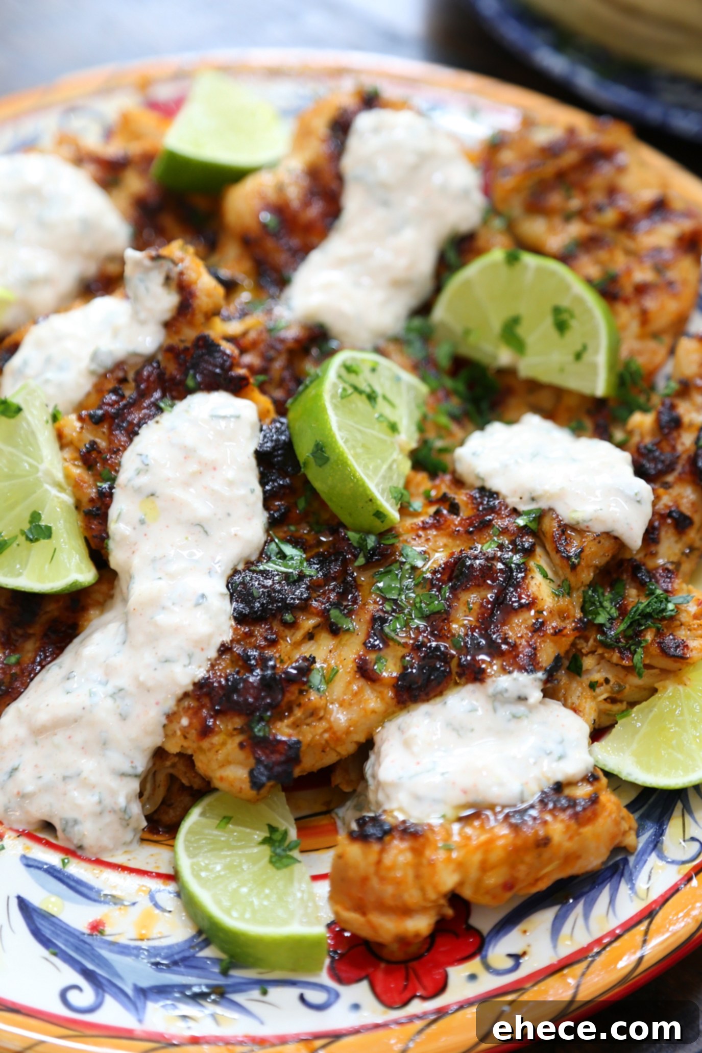 Sizzling Chili Lime Chicken with Refreshing Cucumber Mint 7 Chili-Lime Grilled Chicken and Cucumber-Mint Sauce artfully arranged on a plate with fresh garnishes.