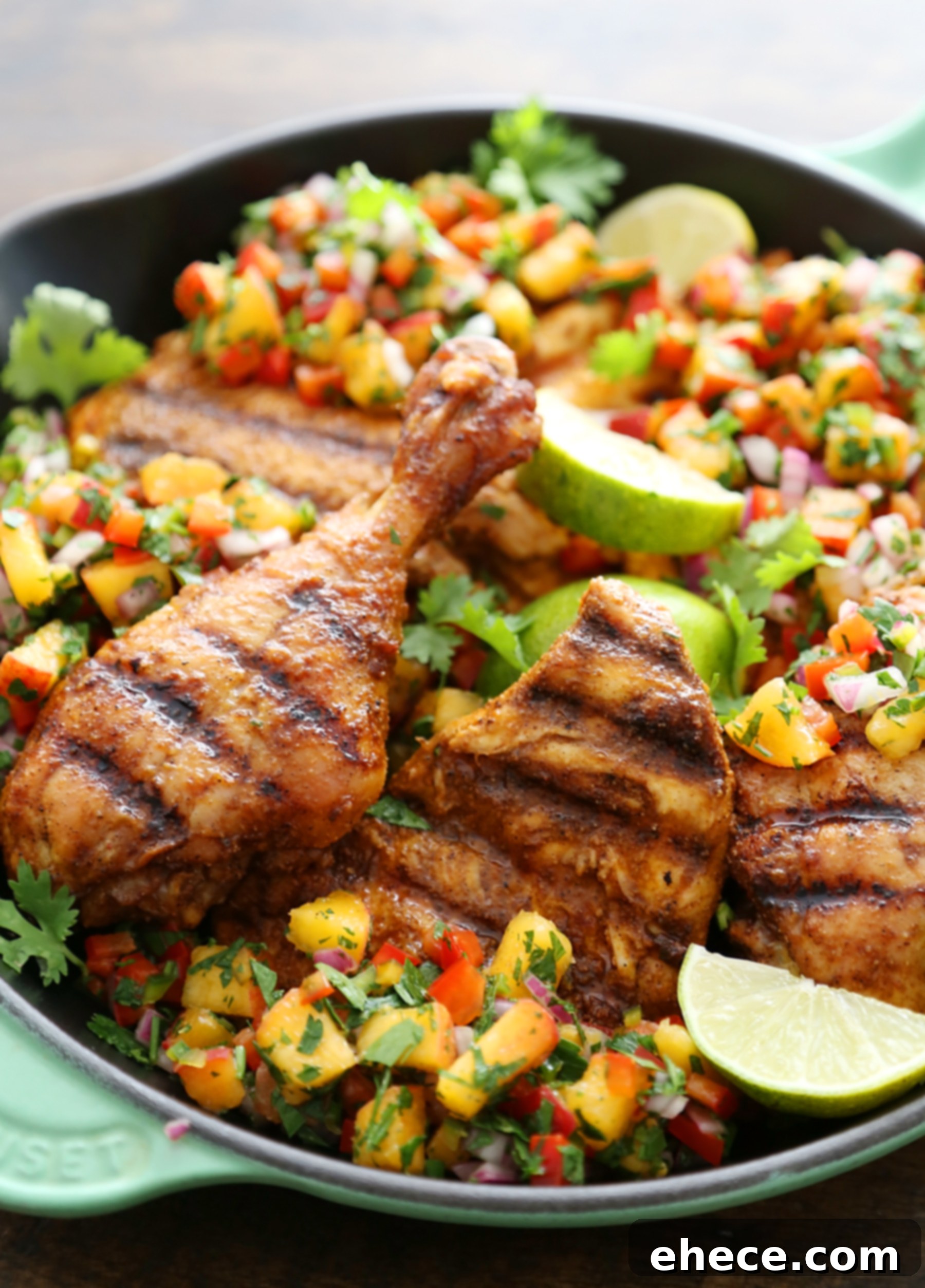 Sweet Heat Grilled Chicken with Peach Salsa 6 Scooping fresh peach salsa onto a piece of grilled chicken.