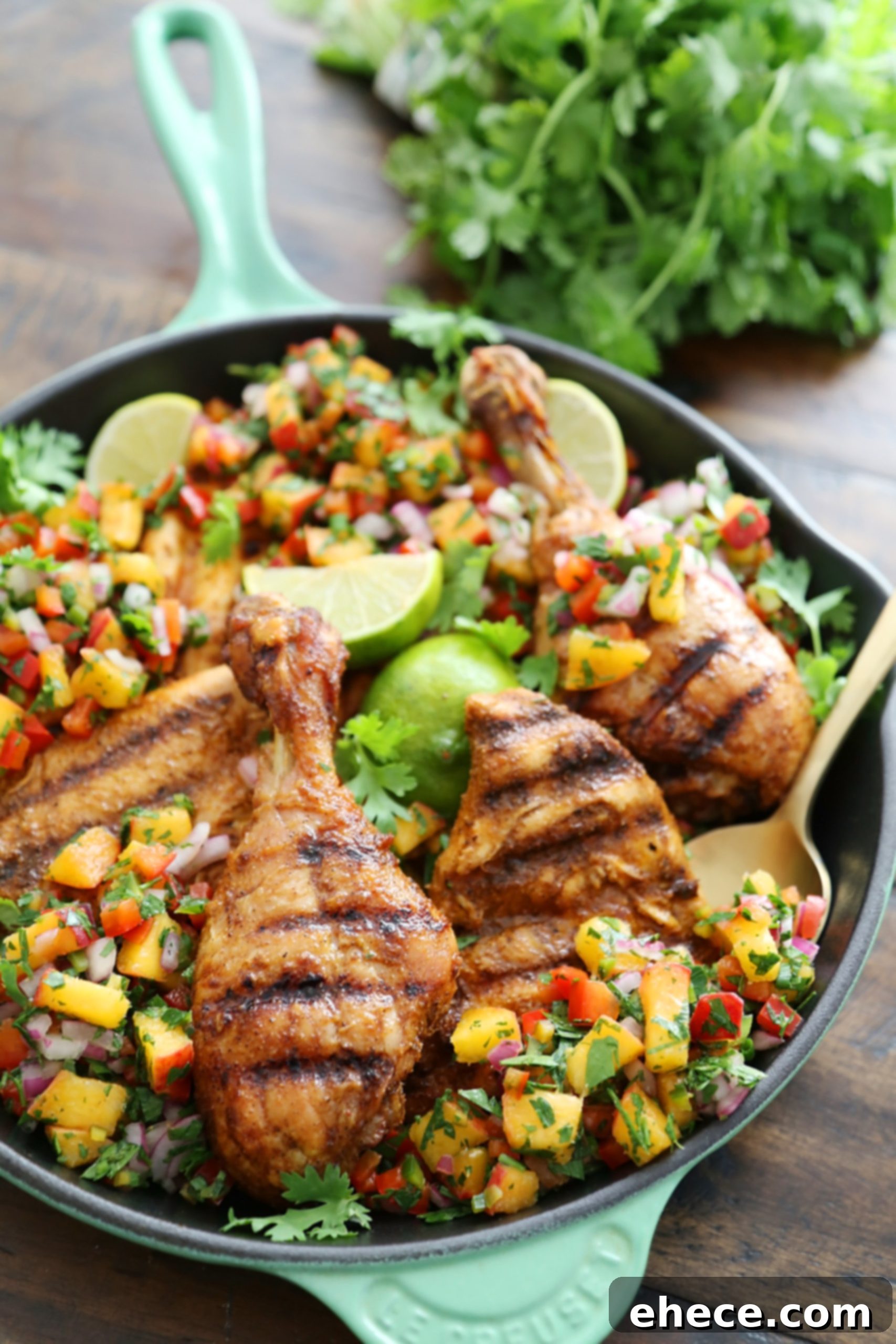 Sweet Heat Grilled Chicken with Peach Salsa 7 Plated grilled chicken with peach salsa, garnished with fresh cilantro and lime wedges.